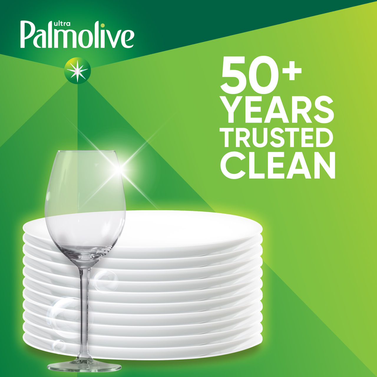 Hands washing dishes at kitchen sink with Palmolive dish soap bottle nearby.