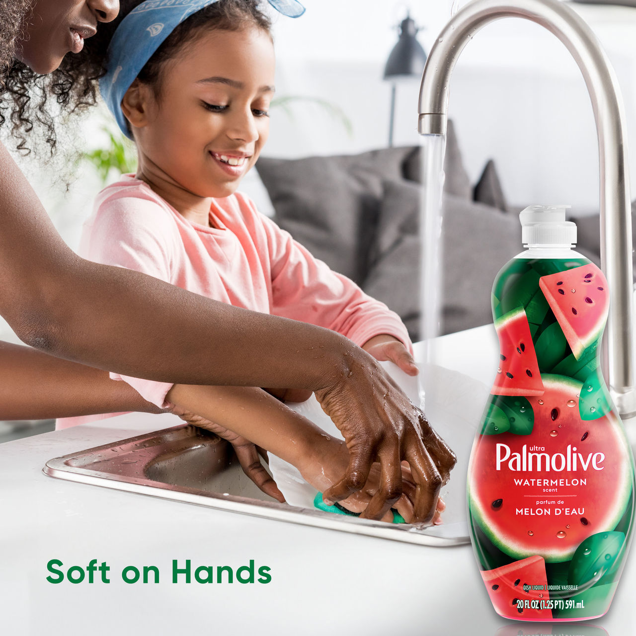 Mother and child washing hands at kitchen sink with Palmolive bottle nearby and text that reads “Soft on Hands”.